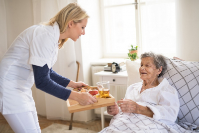 young lady giving foods the elderly woman
