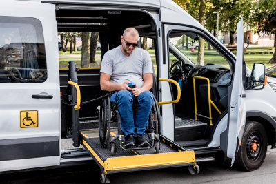 a aman on wheelchair preparing to lift fomr the van