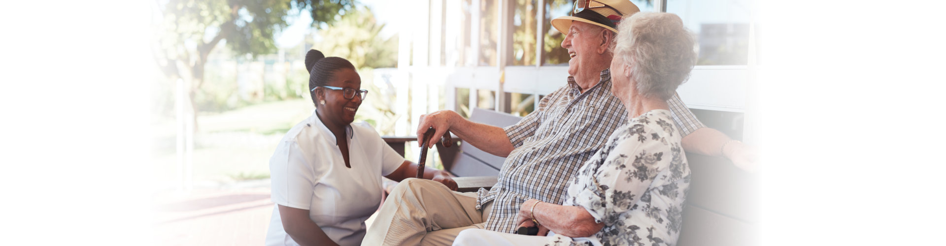 retired couple relaxing outdoor with female caregiver
