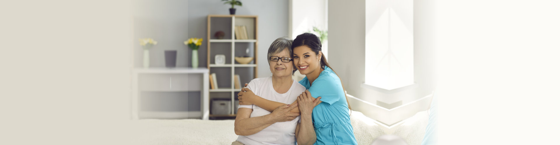 caregiver and elder woman smiling
